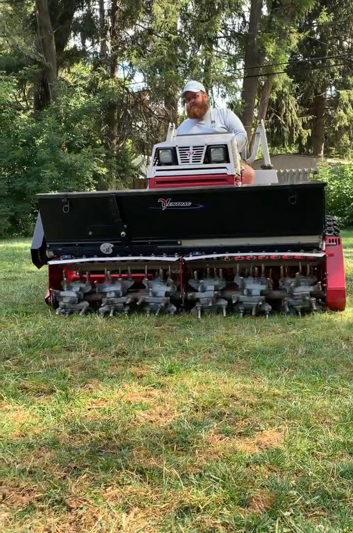 A black pipe with a hose attached to it is spraying water.