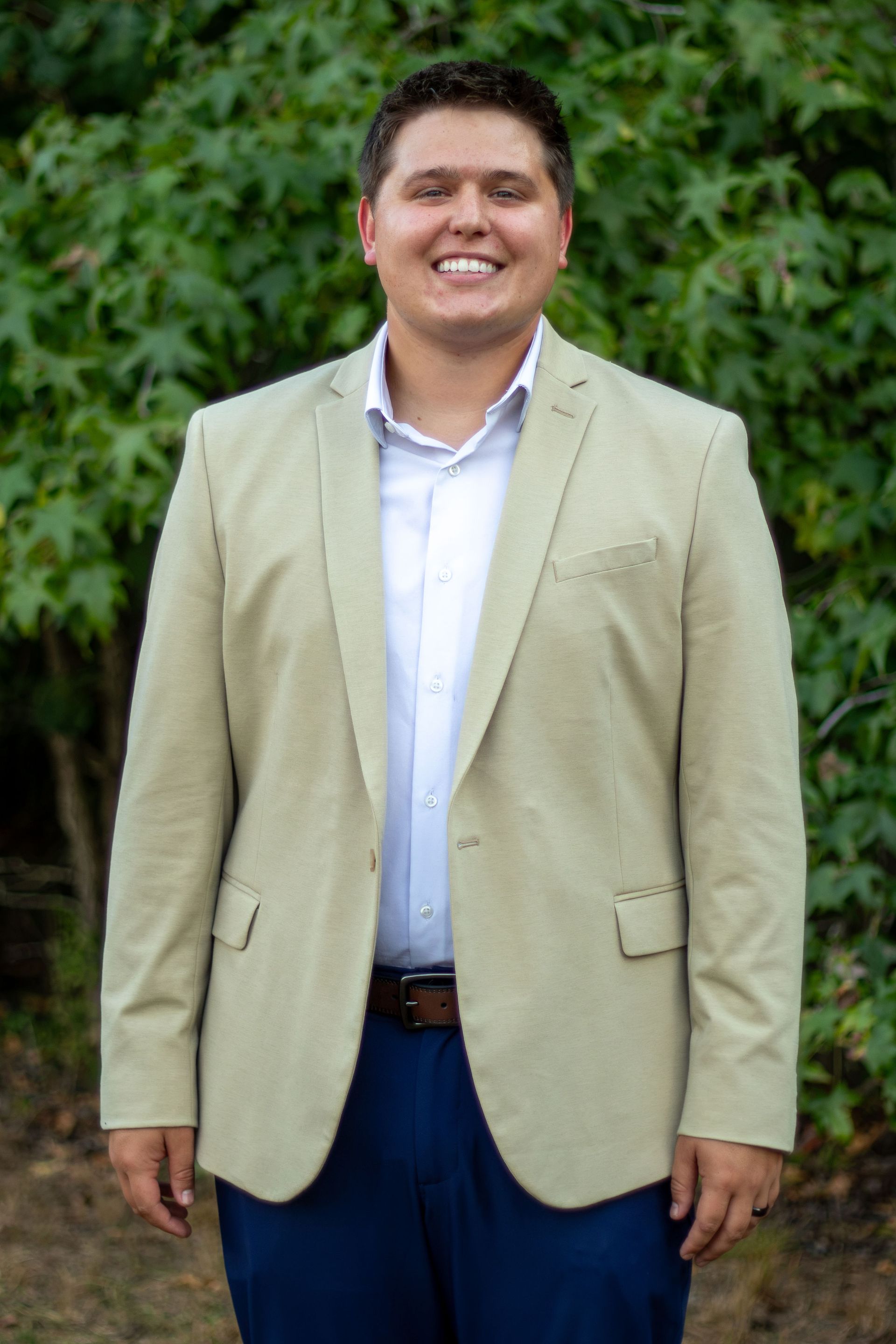 A man in a suit and tie is smiling for the camera.