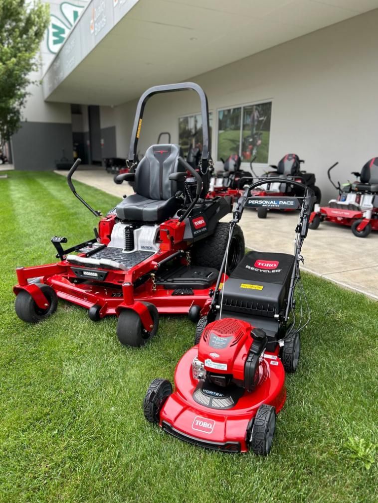 A Row of Lawn Mowers Are Parked in Front of a Building — Ireland's Machinery Pty Ltd In Braemar, NSW