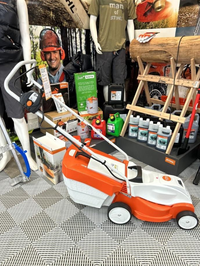 A Lawn Mower is Sitting on Top of a Carpet in a Store — Ireland's Machinery Pty Ltd In Braemar, NSW