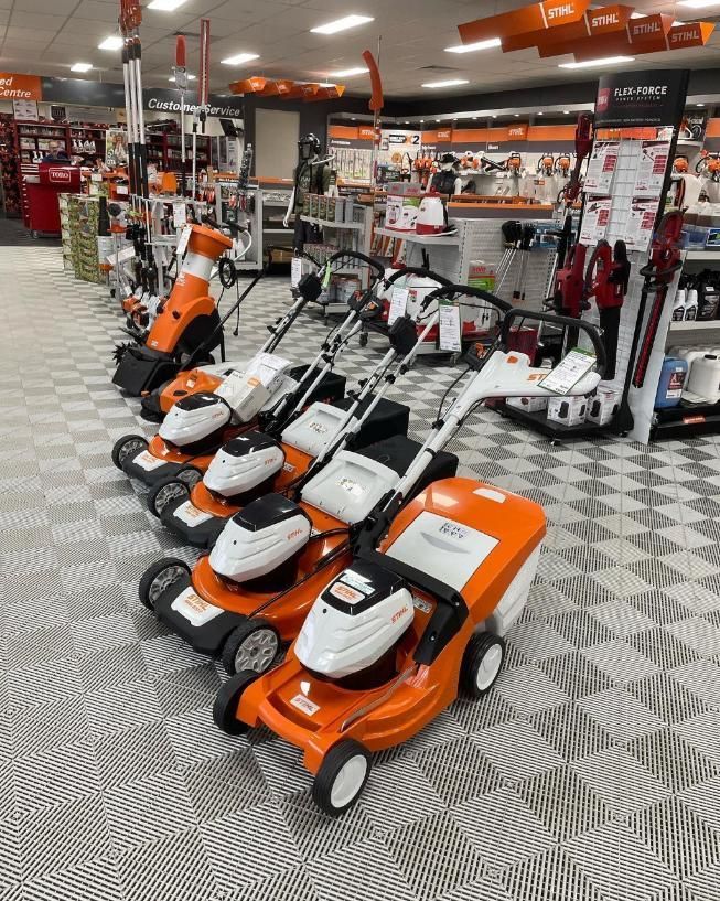 A Row of Lawn Mowers Are Lined Up in a Store — Ireland's Machinery Pty Ltd In Braemar, NSW