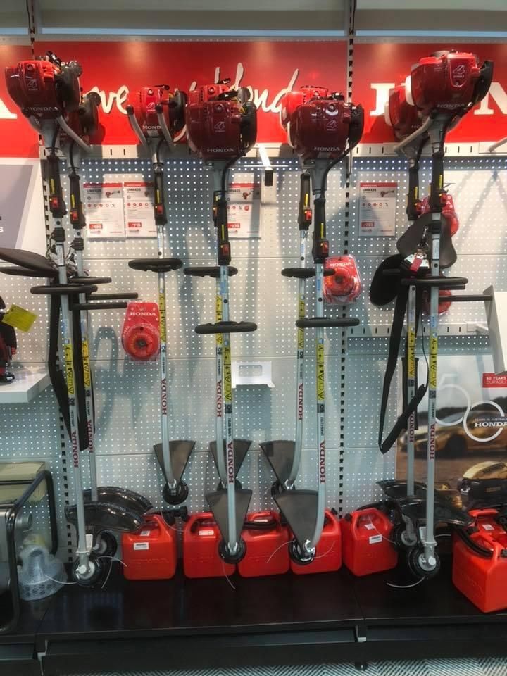 A Row of Lawn Mower's Are Lined Up on a Shelf in a Store — Ireland's Machinery Pty Ltd In Braemar, NSW