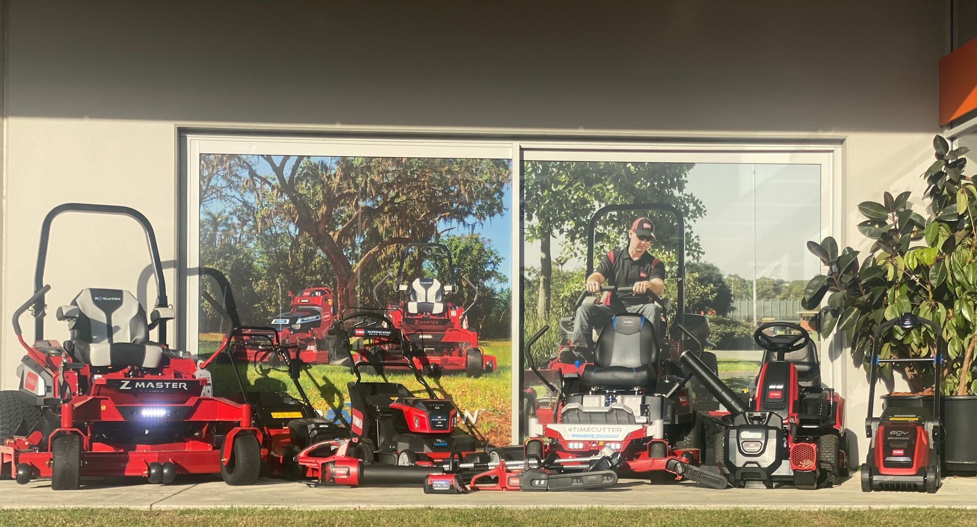 A row of lawn mowers in front of a building — Ireland's Machinery Pty Ltd In Braemar, NSW