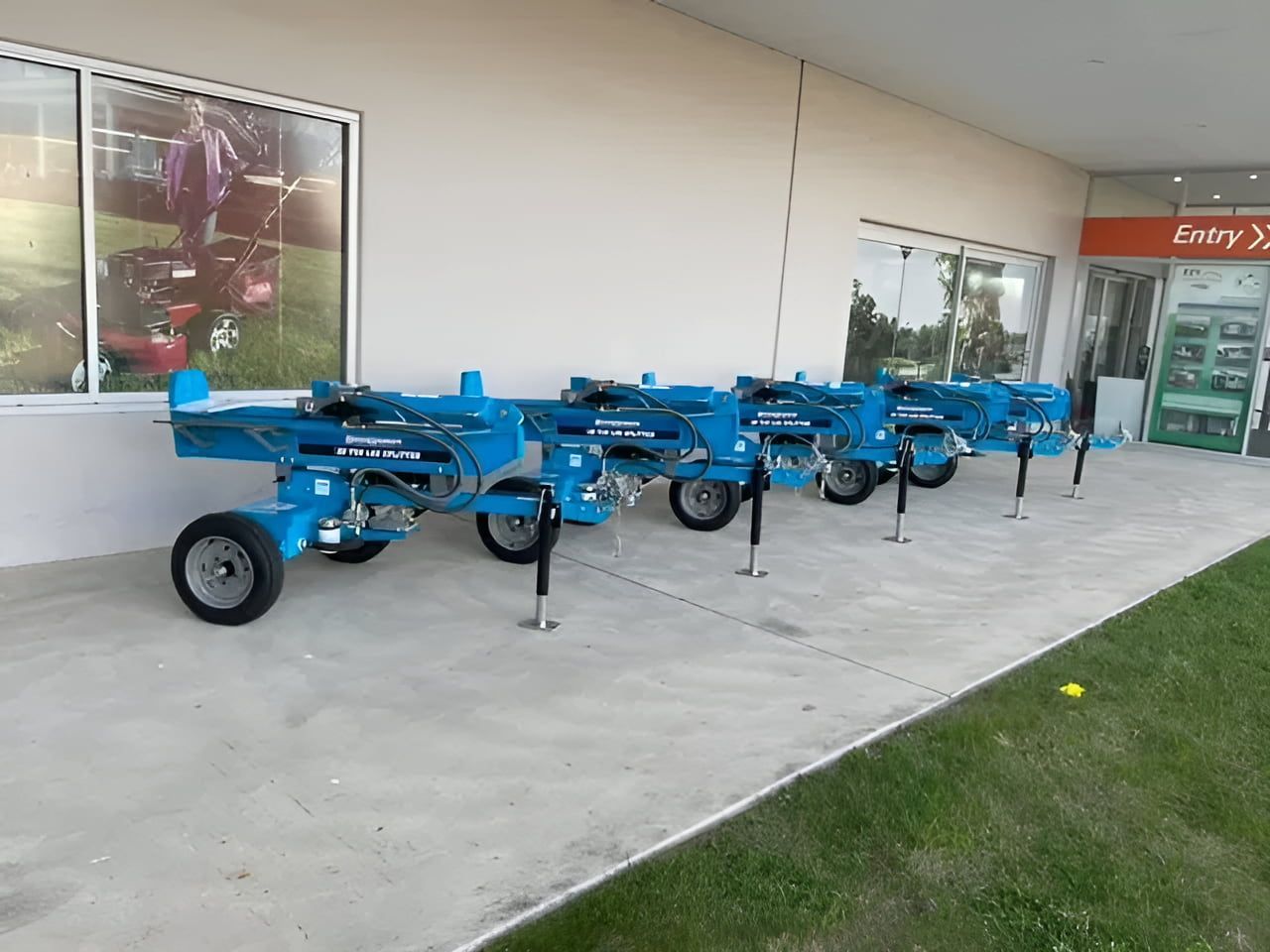 A Row of Blue Tractors Are Parked in Front of a Building — Ireland's Machinery Pty Ltd In Braemar, NSW