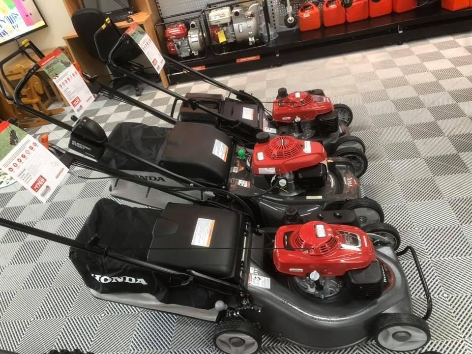 A Row of Lawn Mowers Are Lined Up in a Store — Ireland's Machinery Pty Ltd In Braemar, NSW