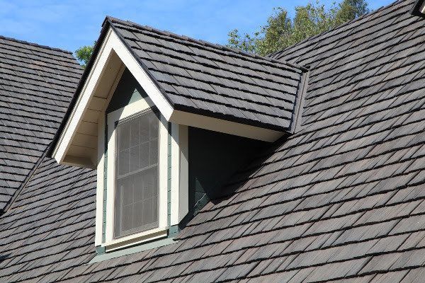 The roof of a house with a window on it