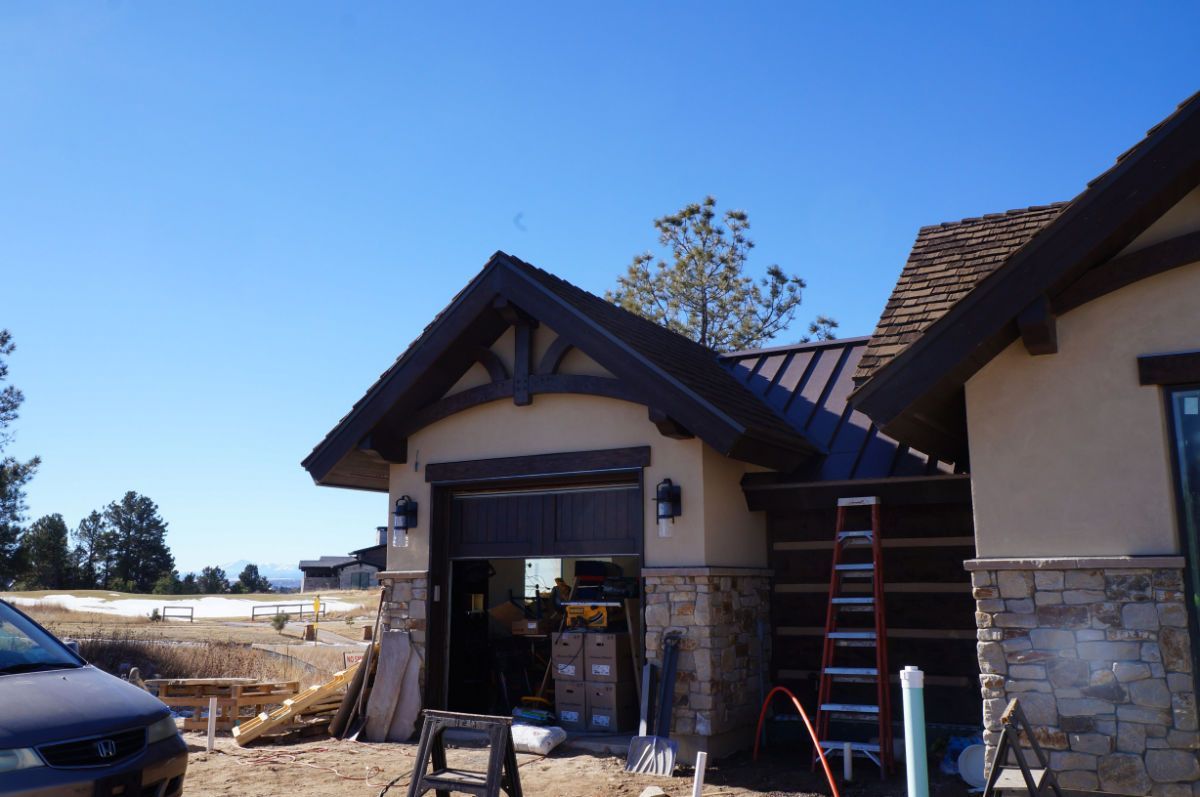 a car is parked in front of a house under construction
