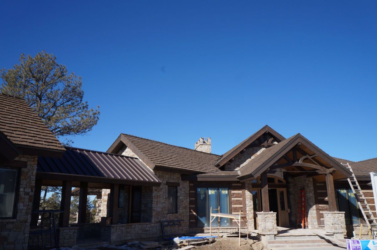 a large house is being built with a blue sky in the background .