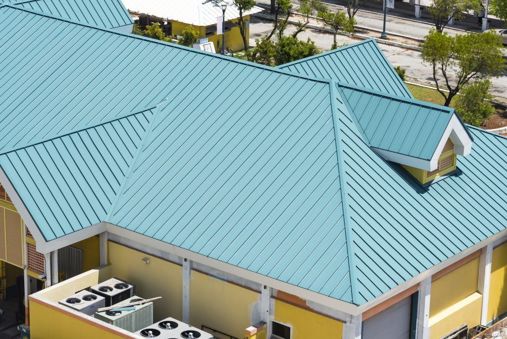 An aerial view of a house with a commercial steel roof