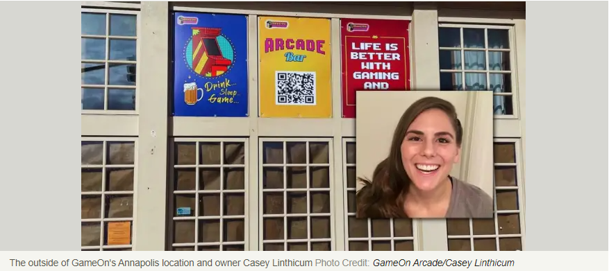 A woman is smiling in front of a building with a sign that says arcade