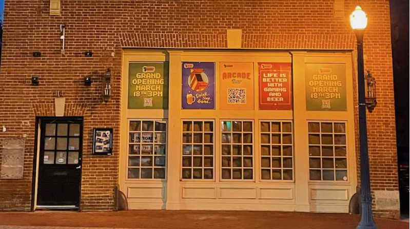 A brick building with a lot of windows and signs on it