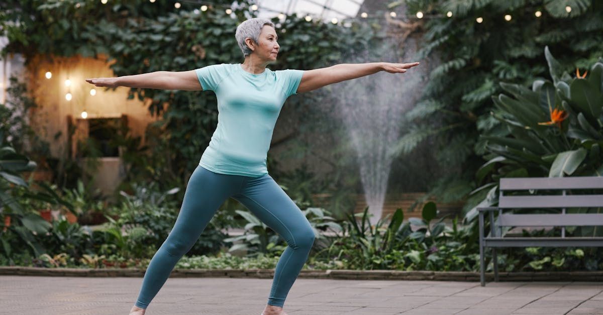 A woman is doing a yoga pose in a park.