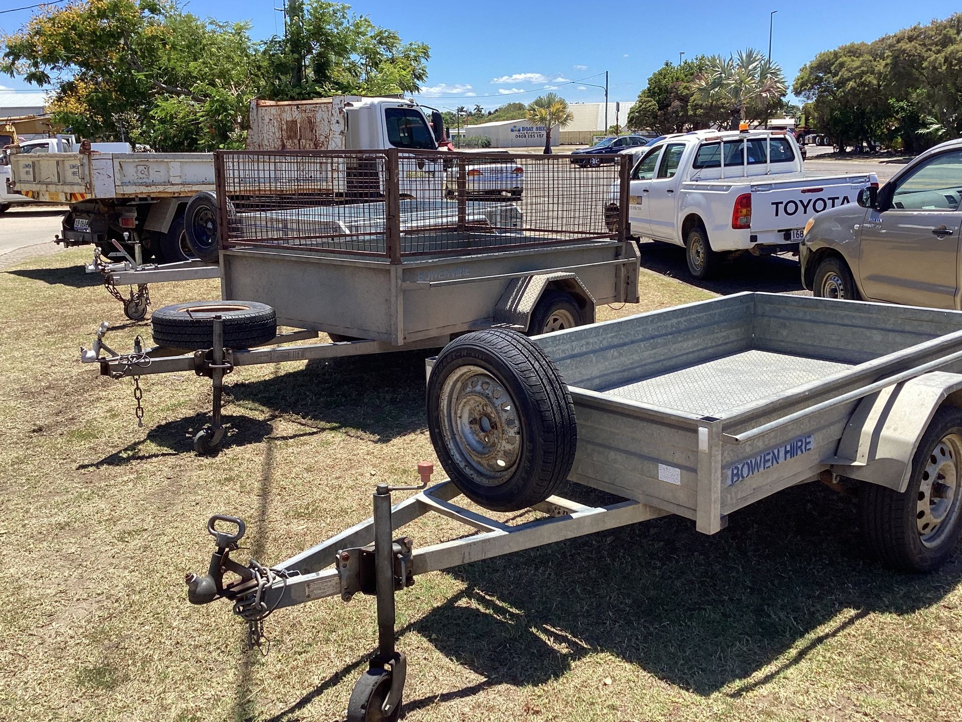 Parked Utility Trailers and A White Pickup Truck — Bowen Hire in Bowen, QLD