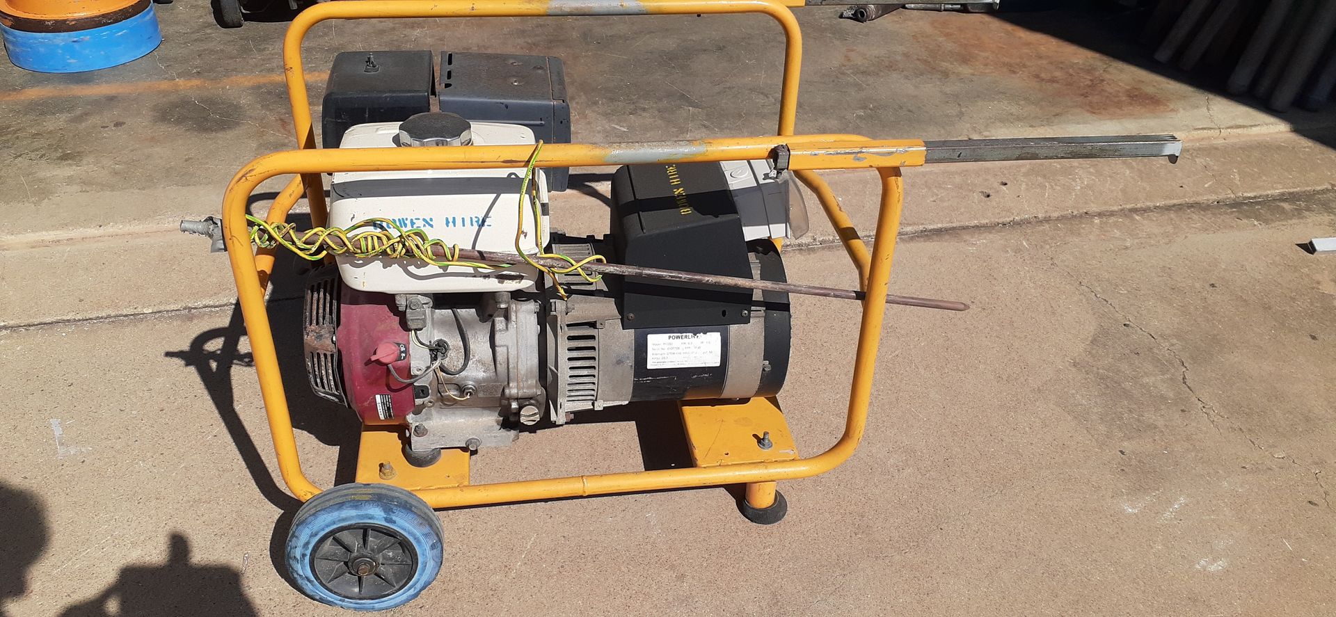 Portable Generator in A Yellow Frame on A Concrete Surface — Bowen Hire in Airlie Beach, QLD
