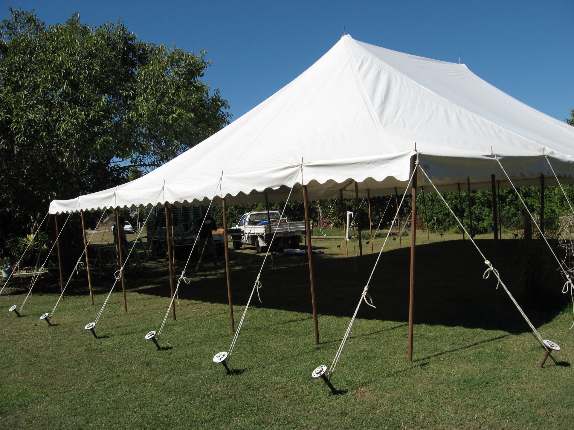 Large White Event Tent with Guy Lines on A Grassy Field — Bowen Hire in Proserpine, QLD