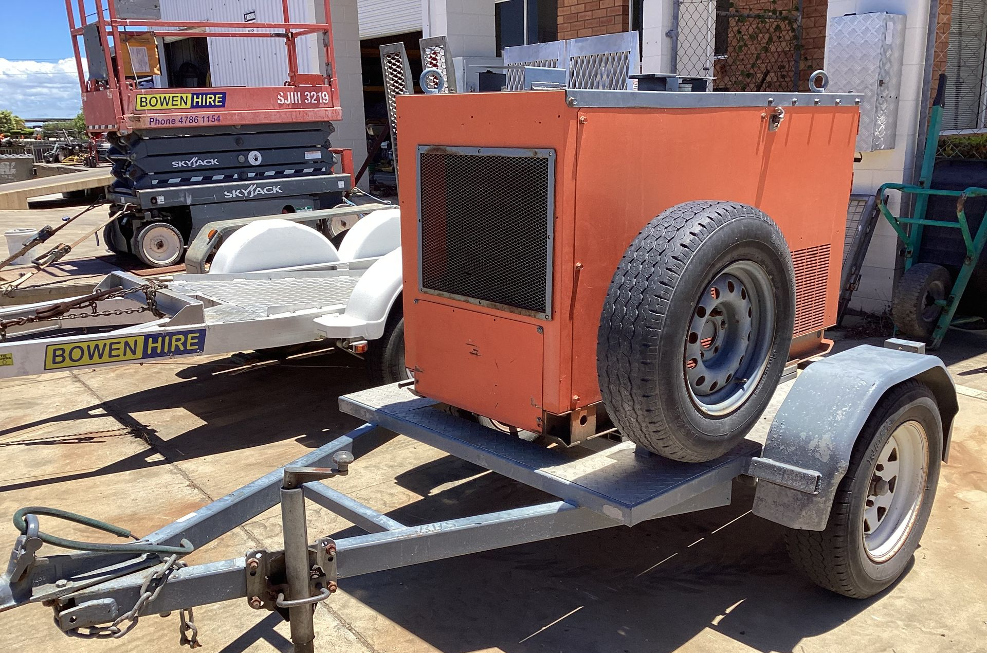 Orange Industrial Machine on A Trailer with A Spare Tire — Bowen Hire in Bowen, QLD