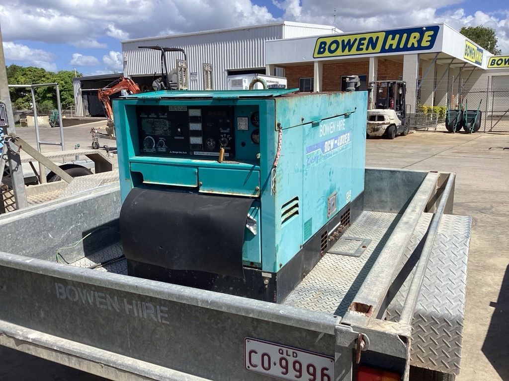 Teal portable generator on a flatbed trailer at a Bowen-Hire yard — Bowen Hire in Bowen, QLD