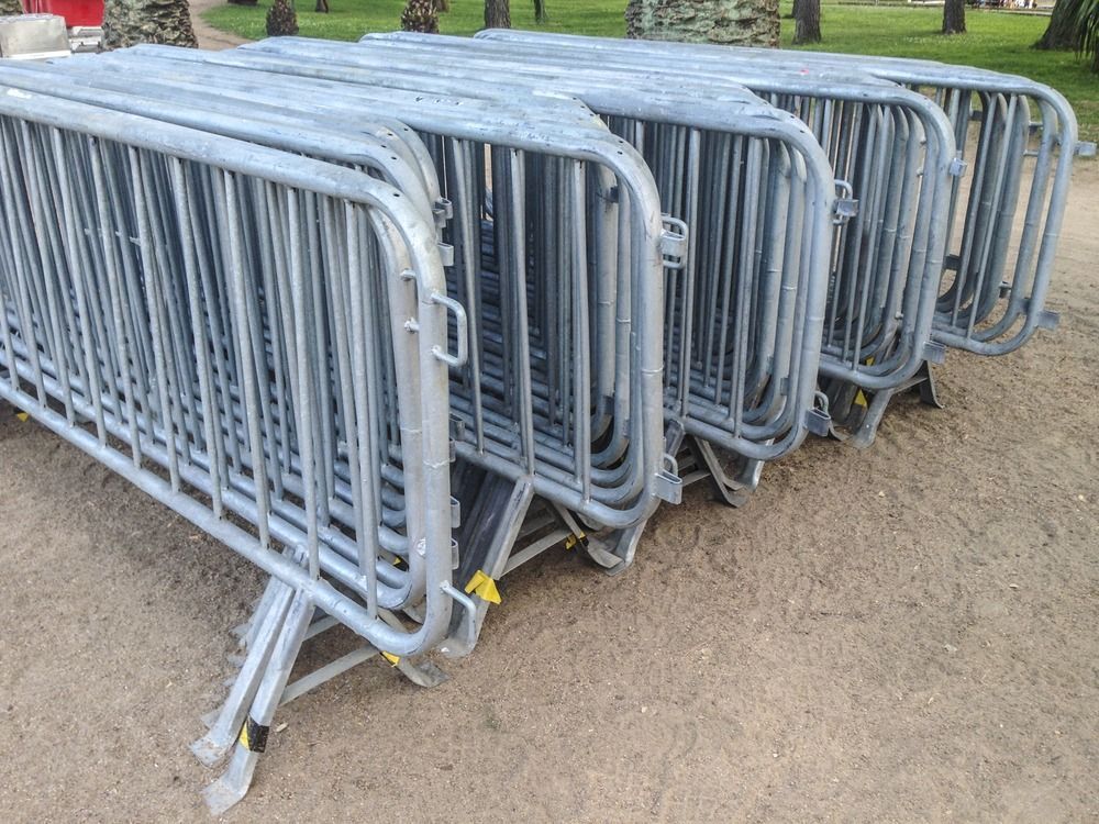 A Maze of Interlocking Metal Crowd-control Barricades Standing on an Asphalt Surface — Bowen Hire in Bowen, QLD