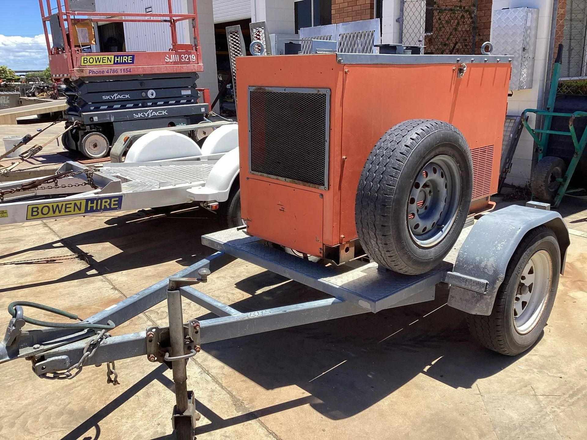 An Orange Portable Industrial Air Compressor Mounted on a Grey Utility Trailer — Bowen Hire in Proserpine, QLD