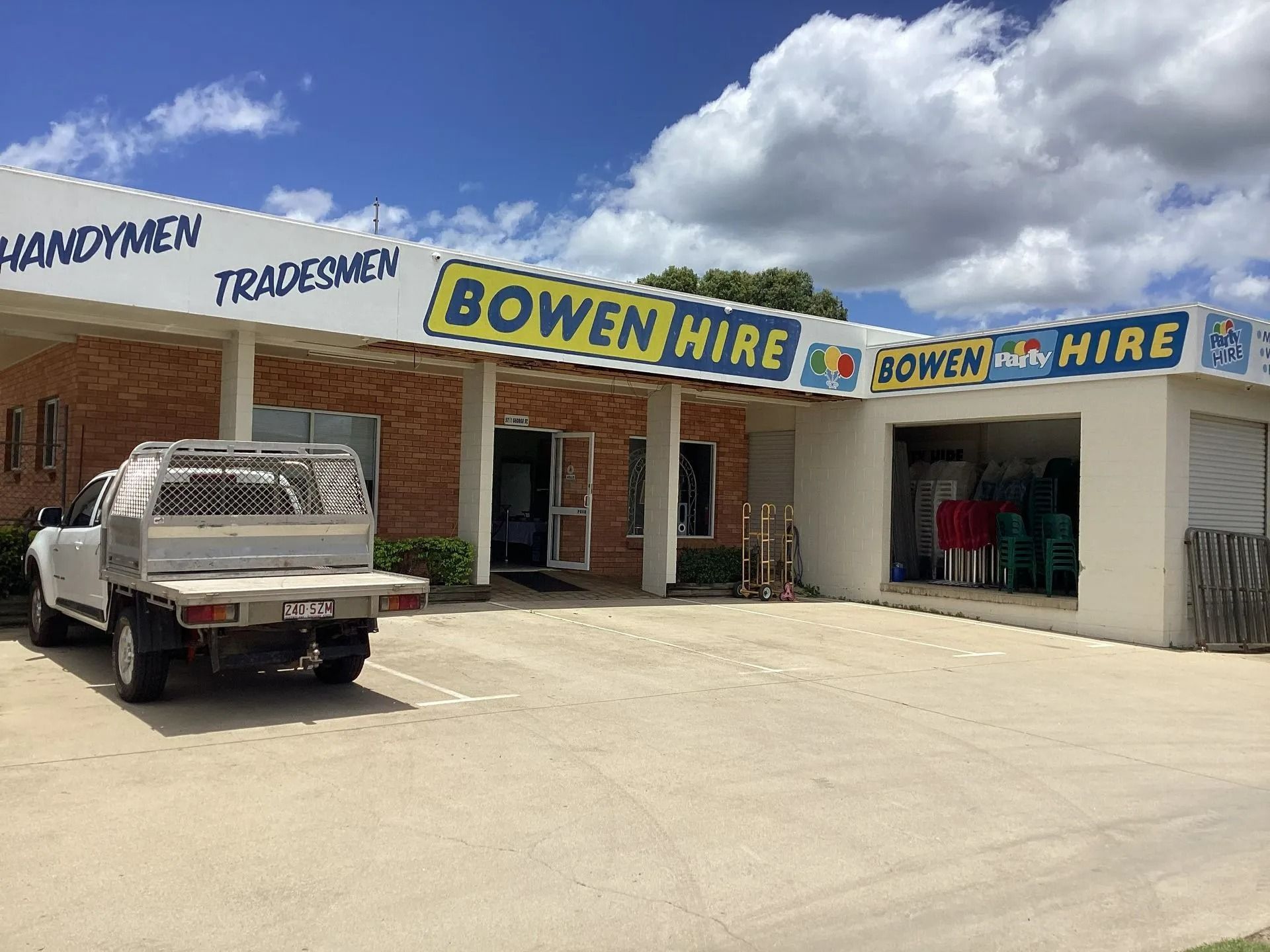 A One-story Building Named Bowen Hire Featuring a Brick Exterior and a White Pickup Truck — Bowen Hire in Bowen, QLD