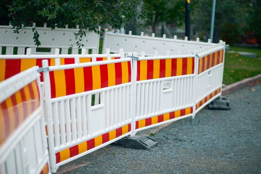 A Series of Red and Yellow Striped Construction Safety Barriers — Bowen Hire in Collinsville, QLD