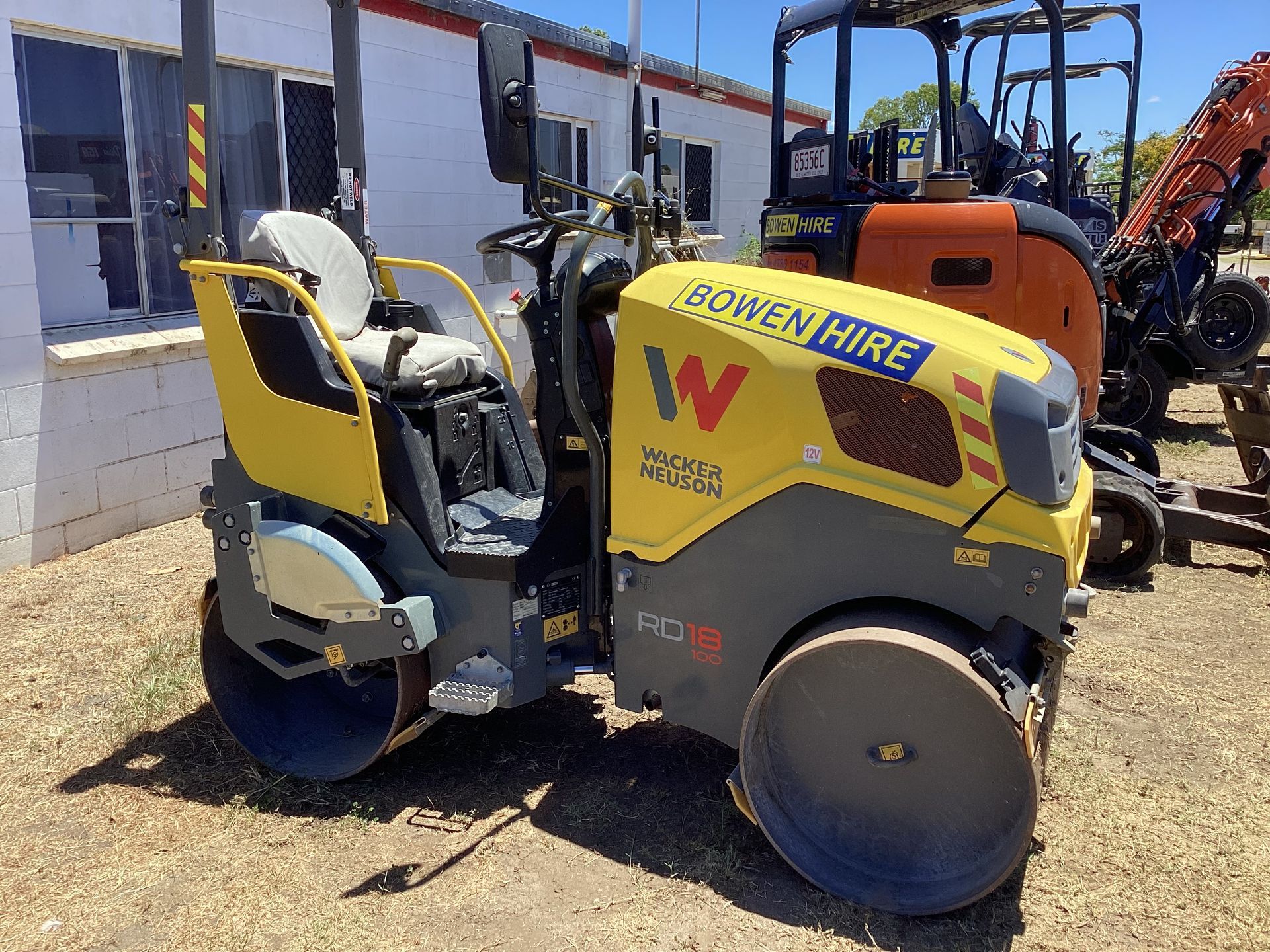 Yellow and Gray Road Roller at a Work Site With Building Materials Nearby — Bowen Hire in Bowen, QLD