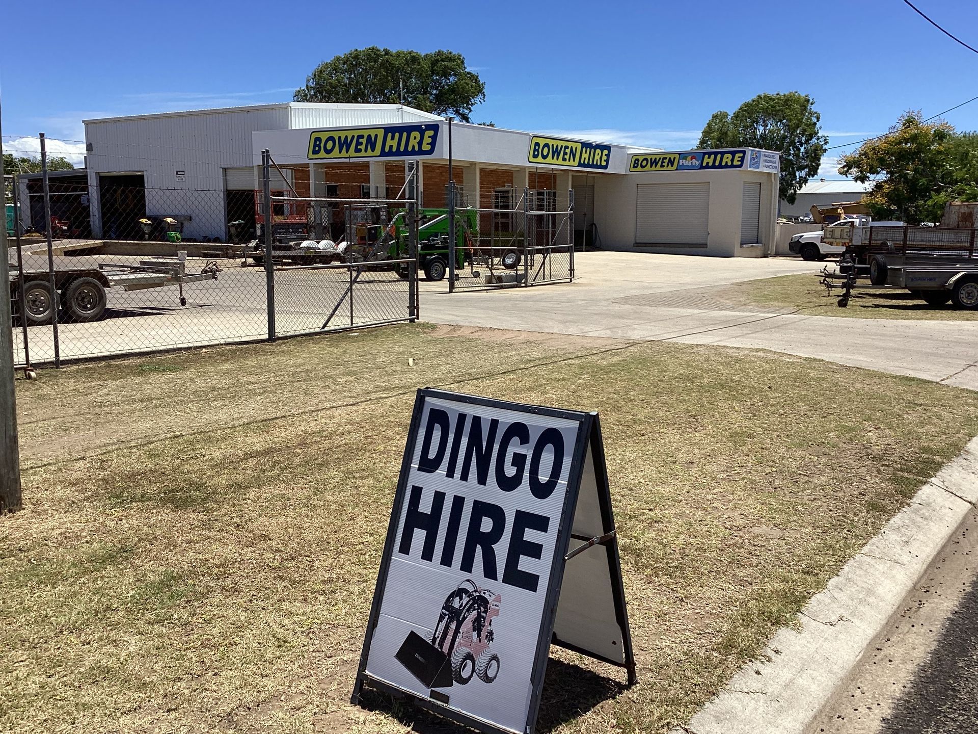 Dingo Hire Sign Outside a Small Roadside Business on a Sunny Day — Bowen Hire in Bowen, QLD