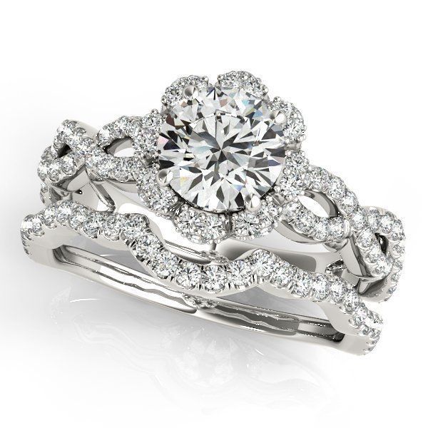 White gold diamond bridal ring set with a round center stone and pavé band on a white background