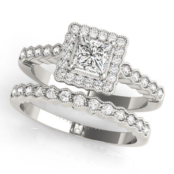 Diamond engagement ring and matching diamond wedding band set on white background