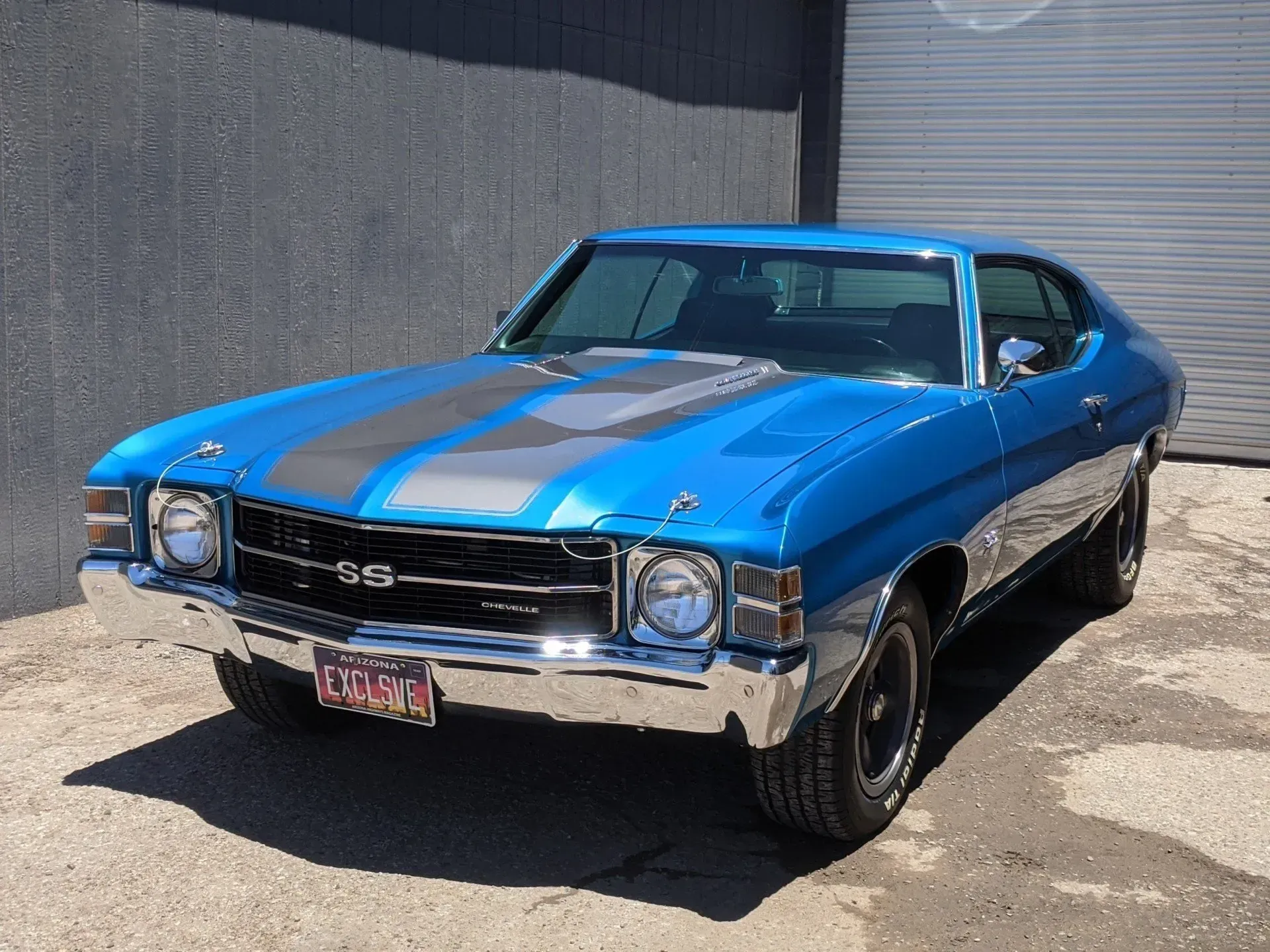 A blue car with a california license plate