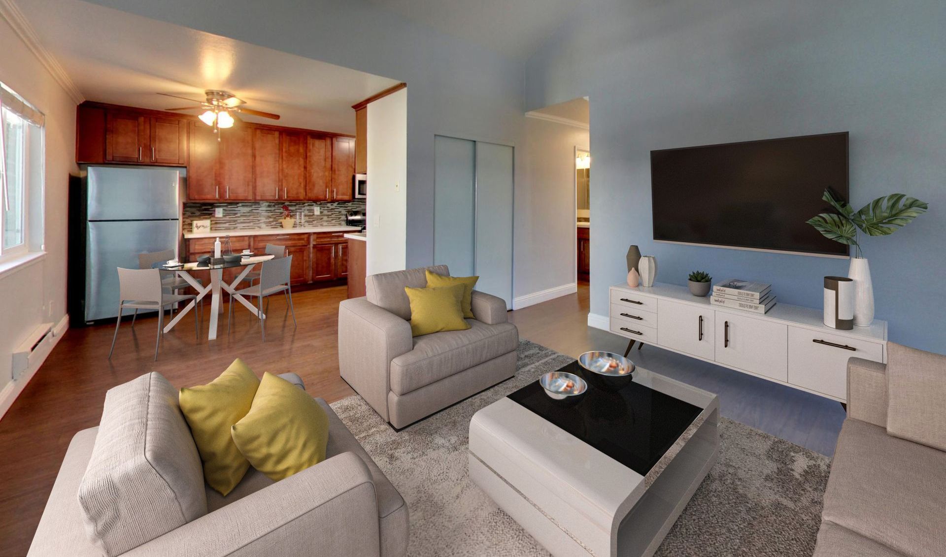 modern living room with a sofa, coffee table, bench, chair, tv and onlooking to a patio