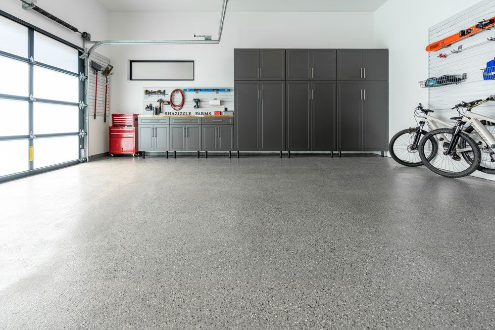 A garage filled with lots of cabinets and bikes.
