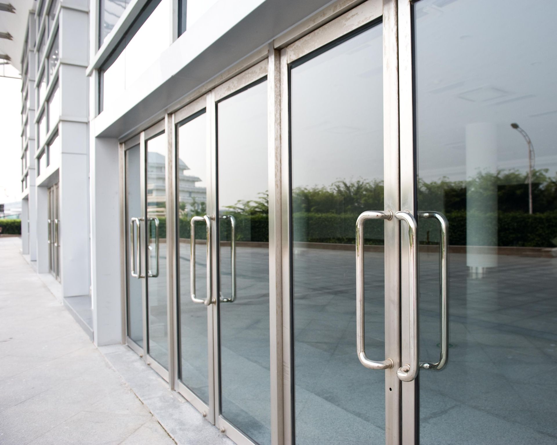 Glass storefront doors with metal handles on a modern building entrance