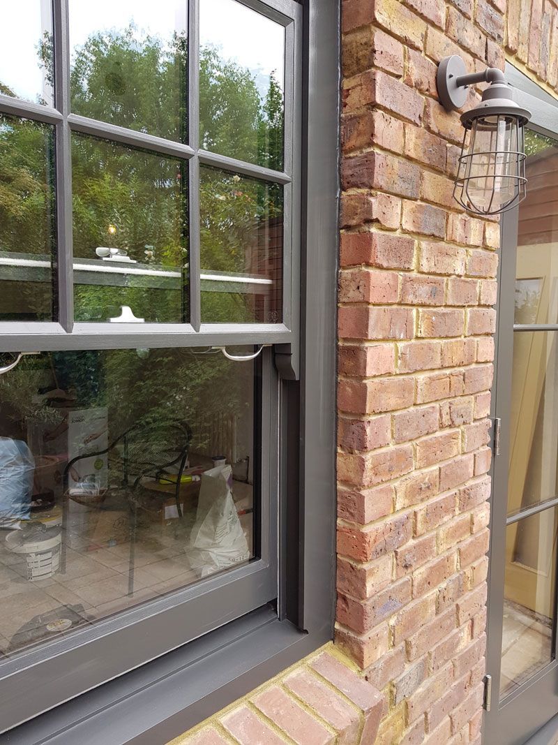 a brick wall with a window and a light on it