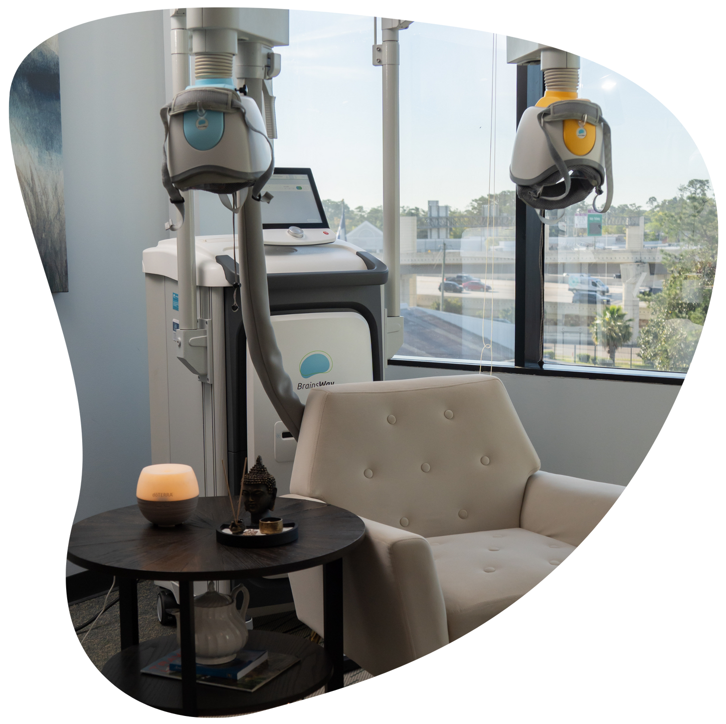Robotic arm beside cream chair and round table in a bright modern office lounge by large windows