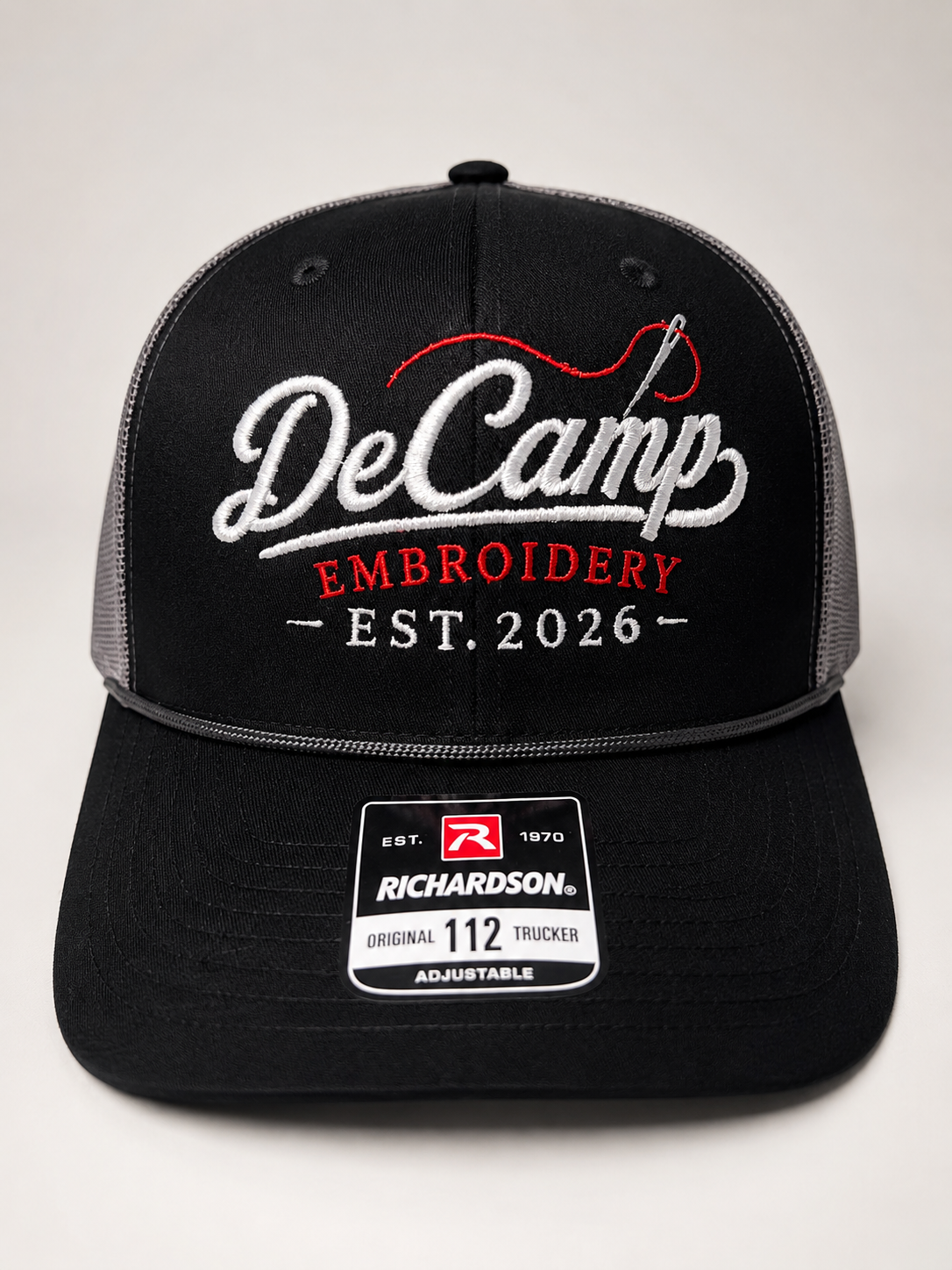 Black Richardson cap with DeCamp Embroidery logo and