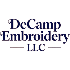 DeCamp Embroidery LLC logo in dark blue serif text with thin decorative lines on a white background