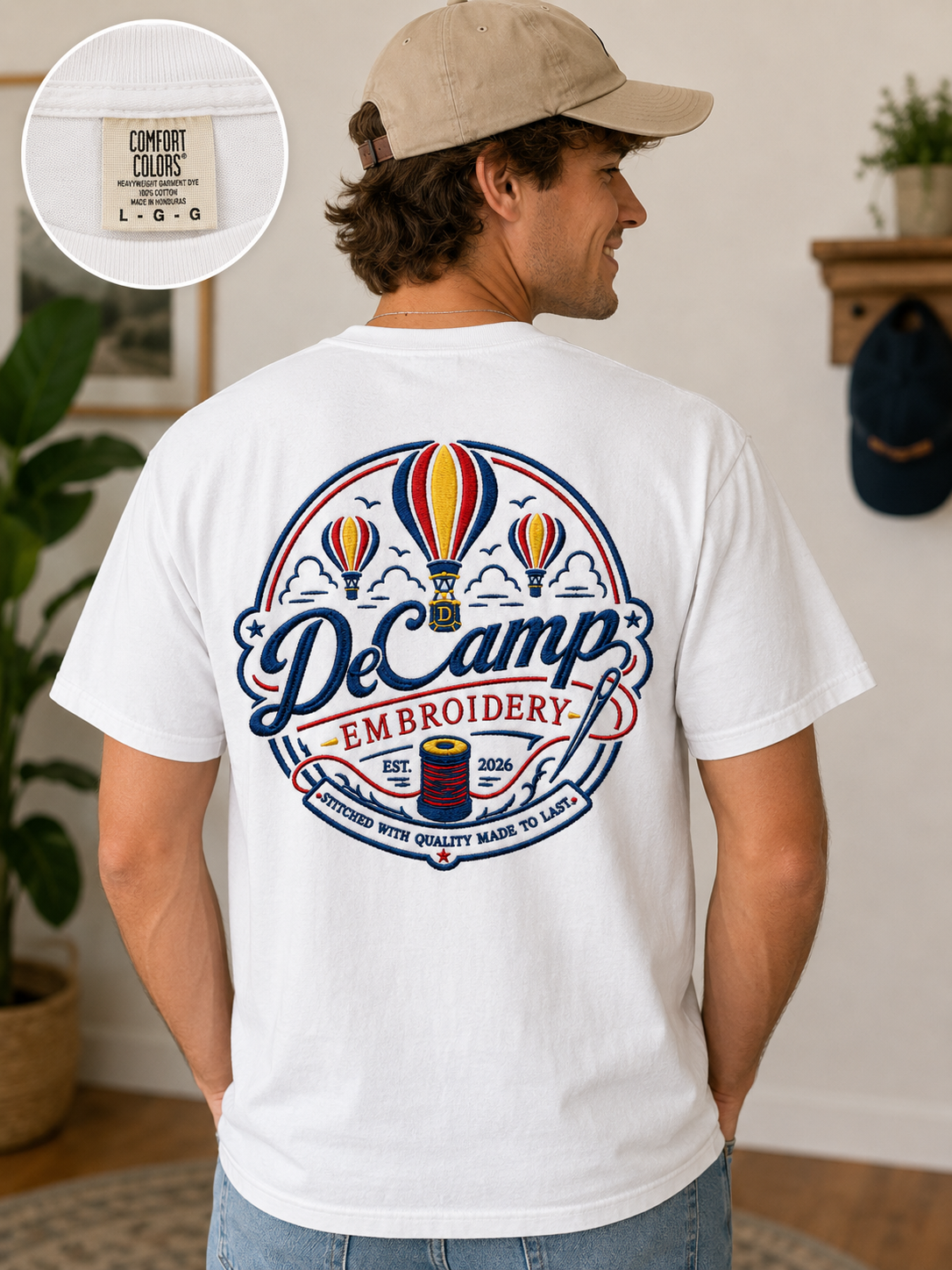 Man wearing a white graphic T-shirt with colorful balloon design, seen from behind in a room.