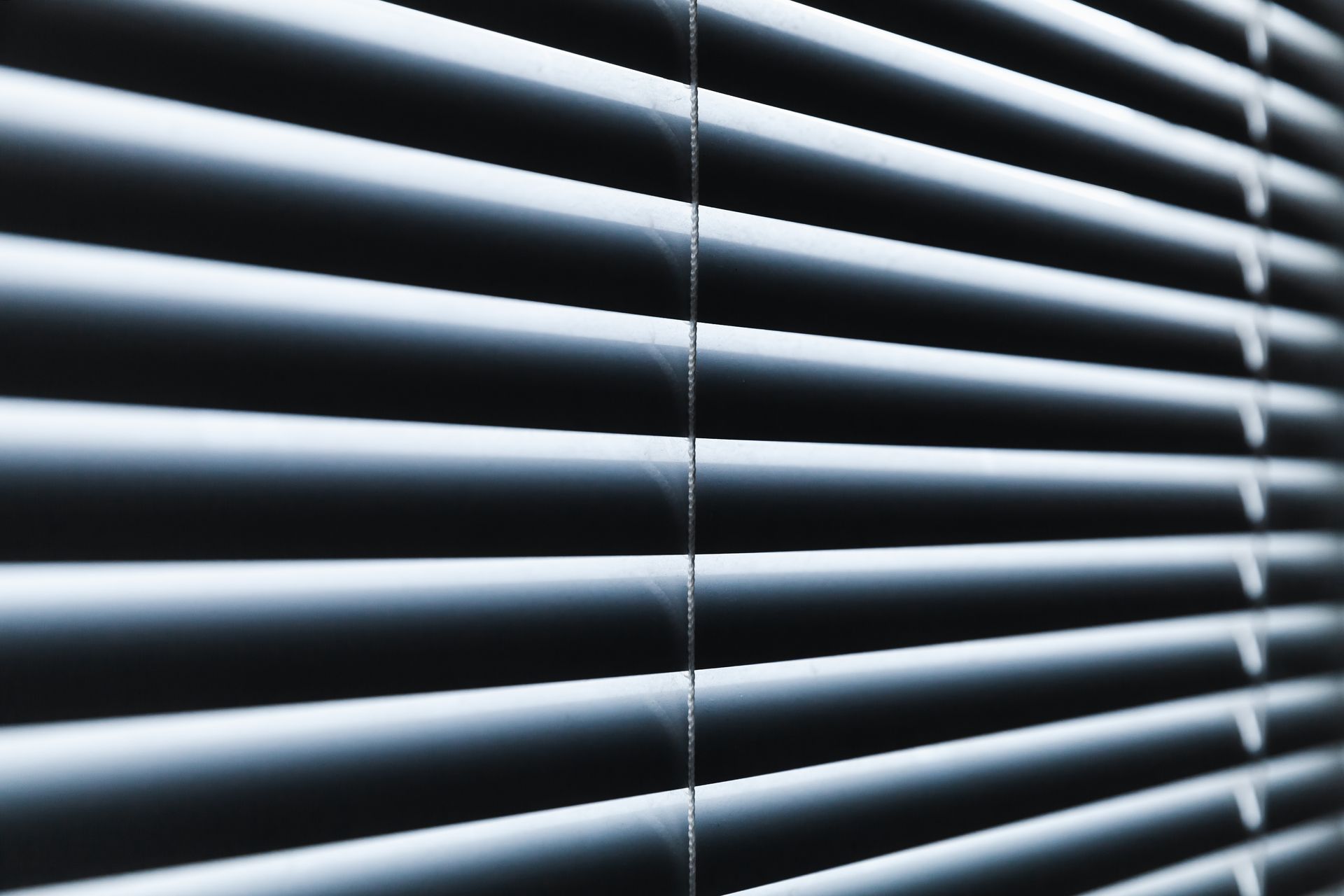 Close-up of furniture and the texture of window shades, highlighting materials and design details.