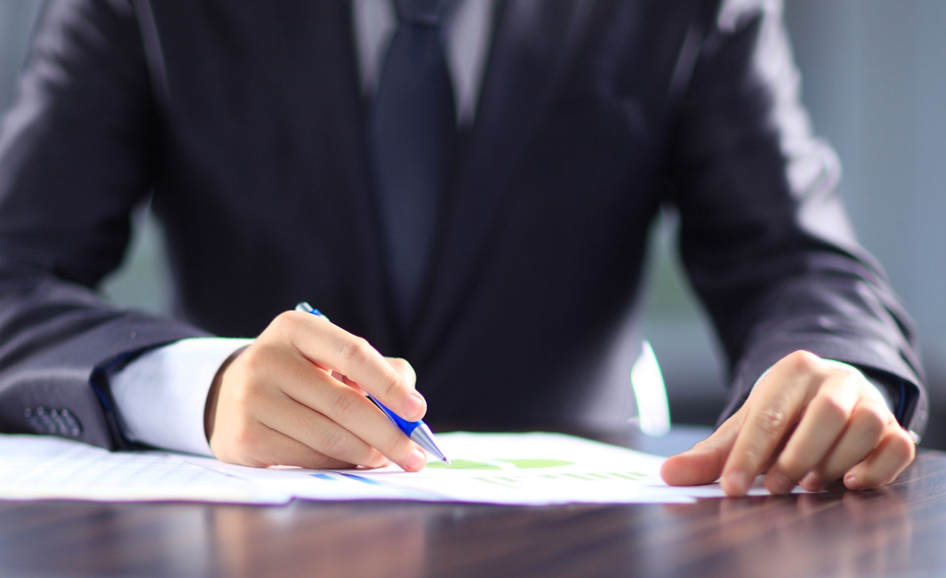 man in suit taking notes