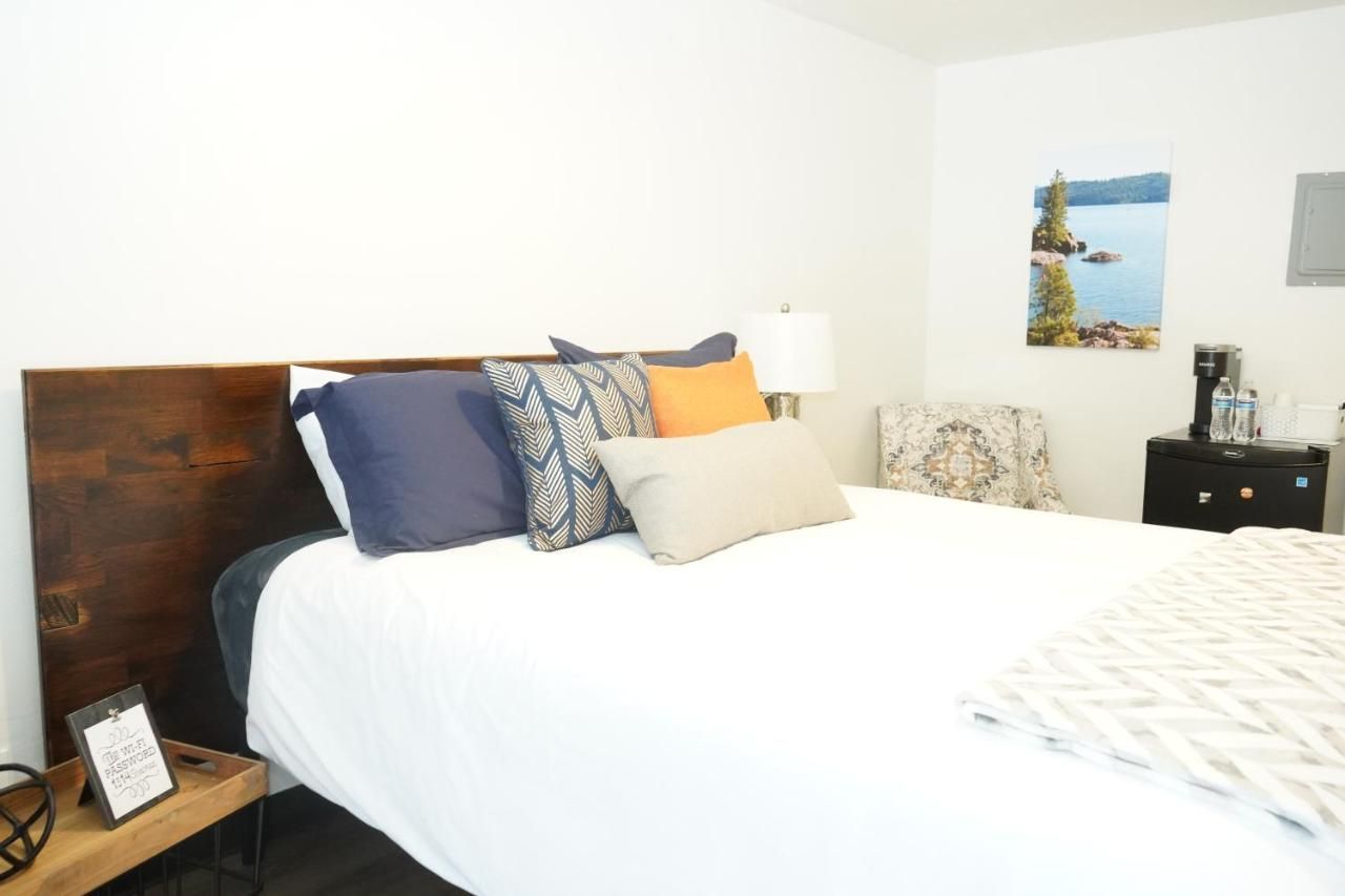 a bed with three pillows on it including one that says love