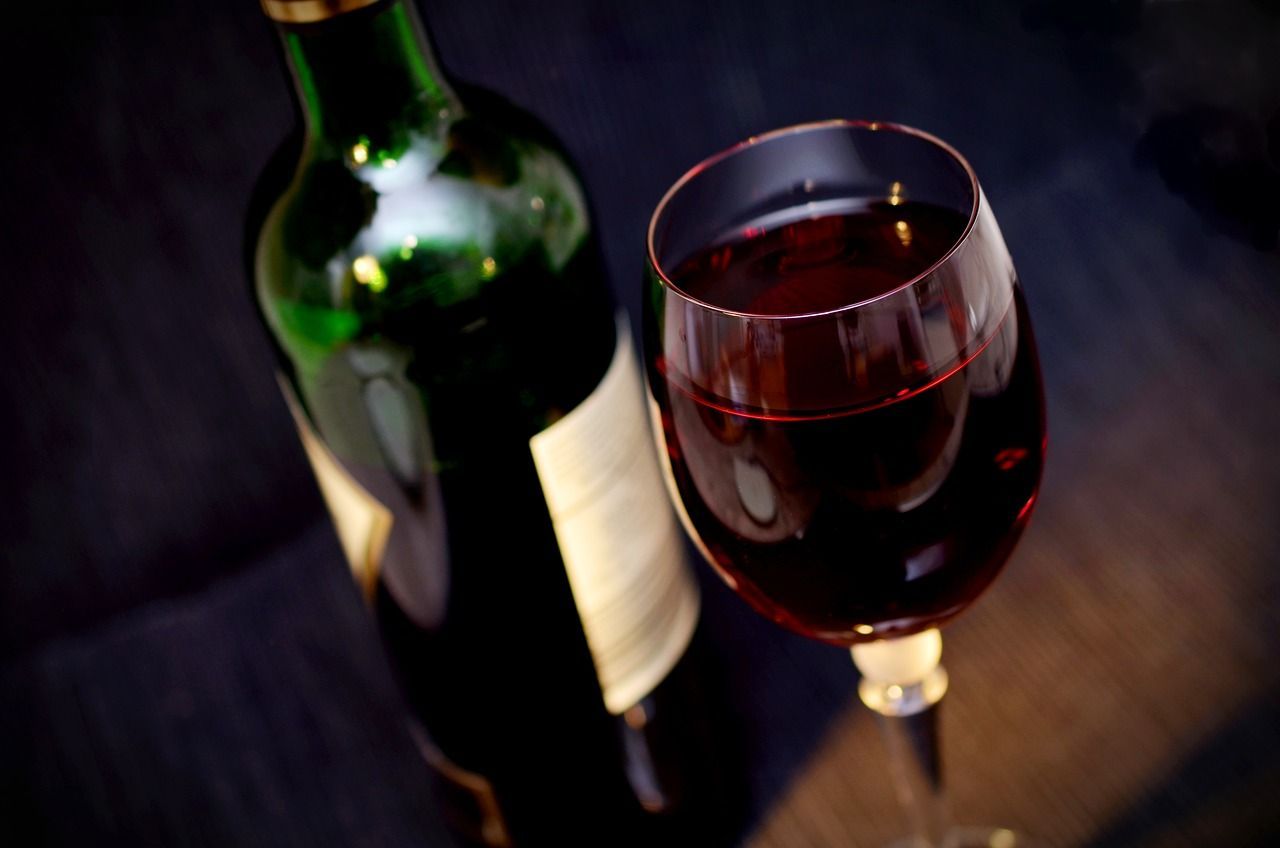 a bottle of wine and a glass of wine are on a table .