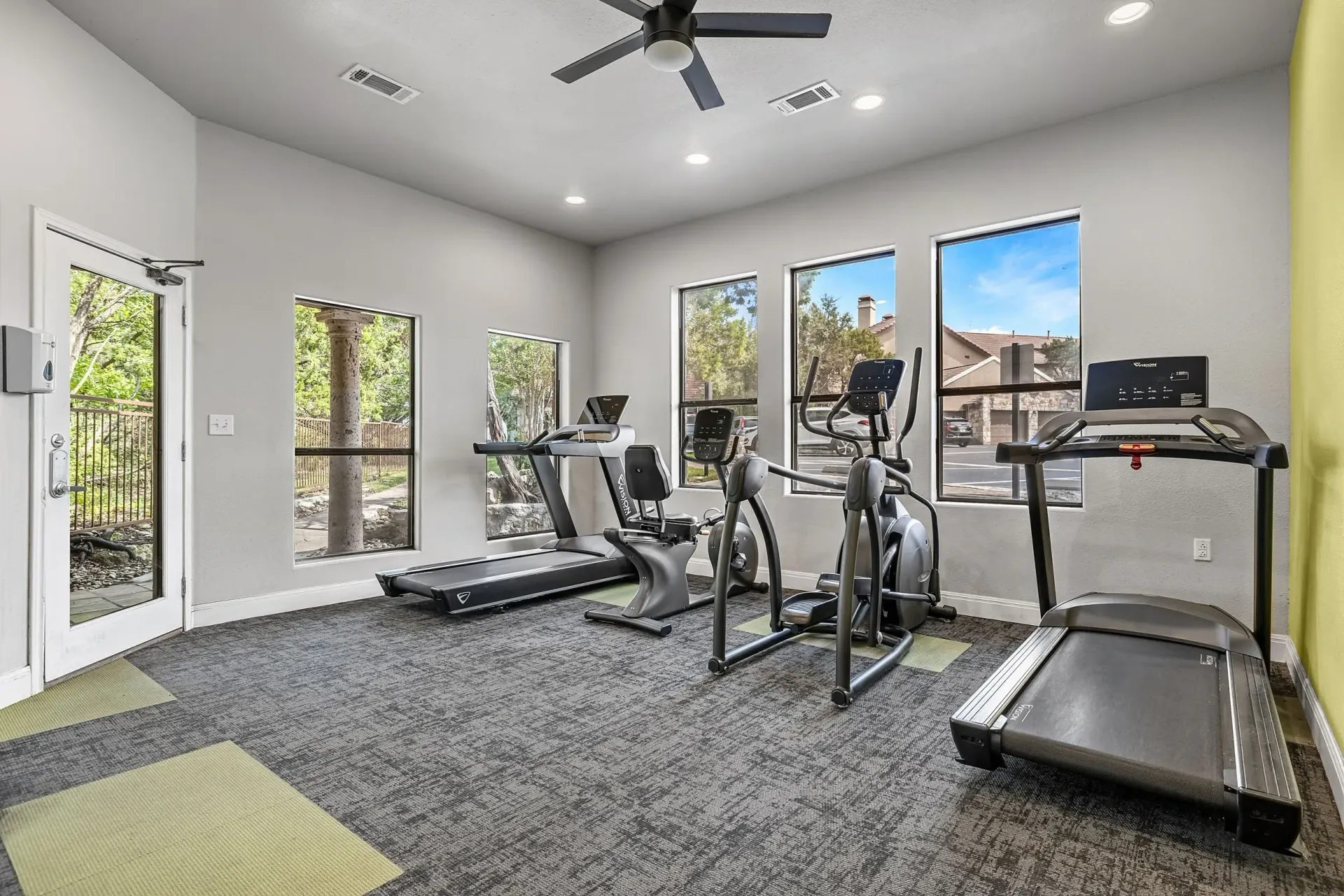 Fitness center with treadmills and elliptical machines.