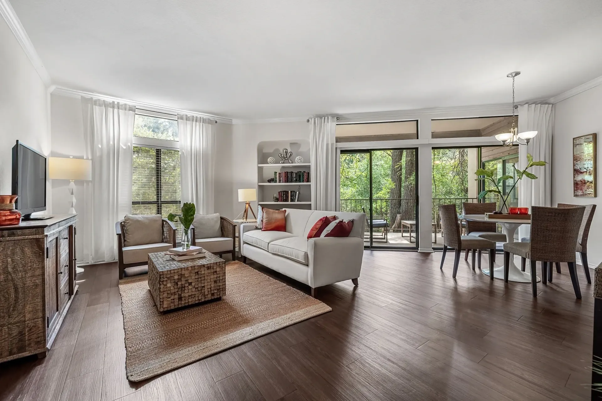 Living room and dining area with sofa, chairs, coffee table, and dining set.