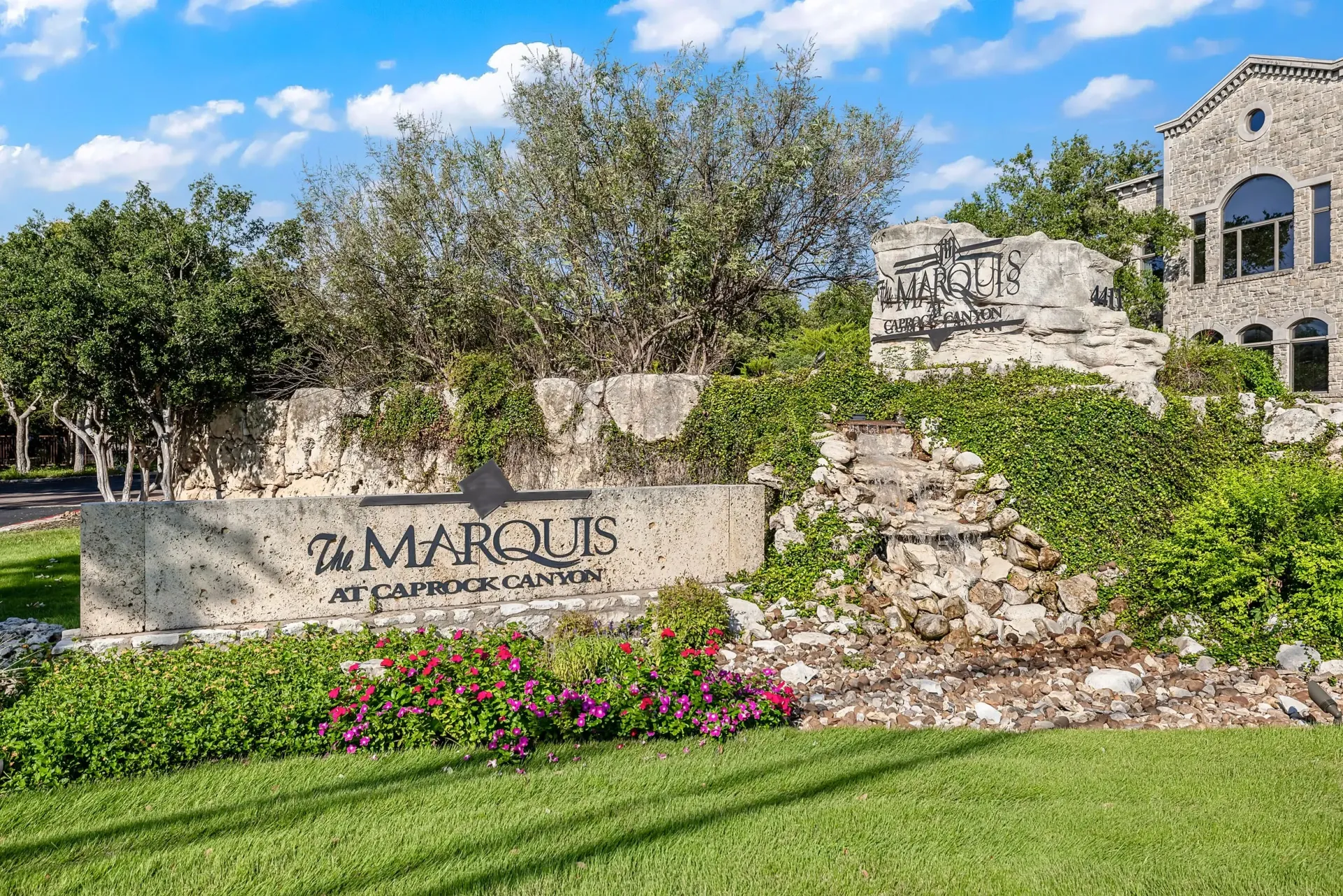 The Marquis at Caprock Canyon monument sign with landscaping and fountain.