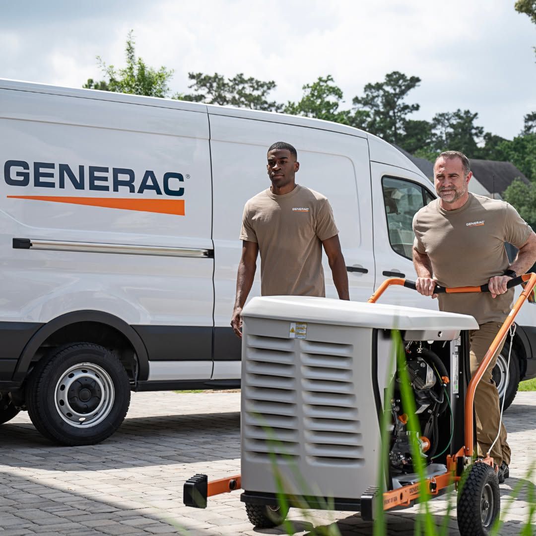 Two workers move a Generac generator beside a white service van outdoors