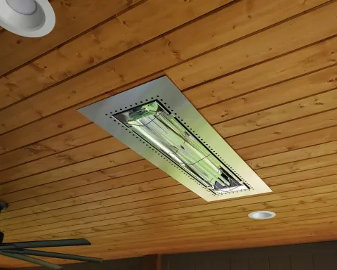 Ceiling with a rectangular fluorescent light fixture and wooden paneling around it