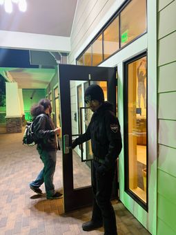 A man is opening a door for a woman