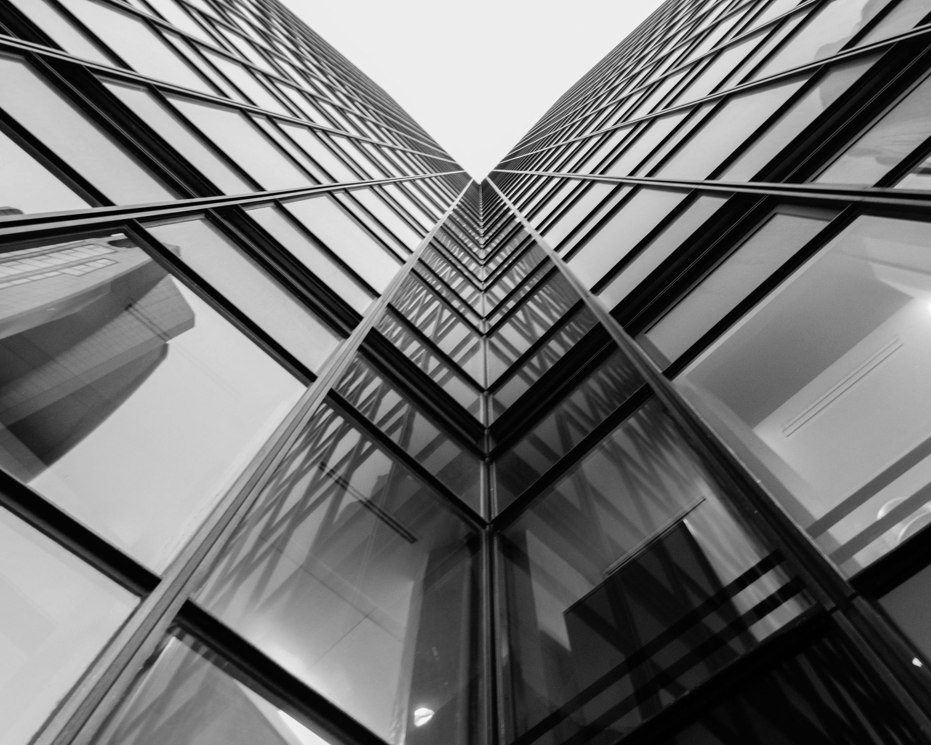 Person walks up curved staircase in a building, silhouetted against a bright background.