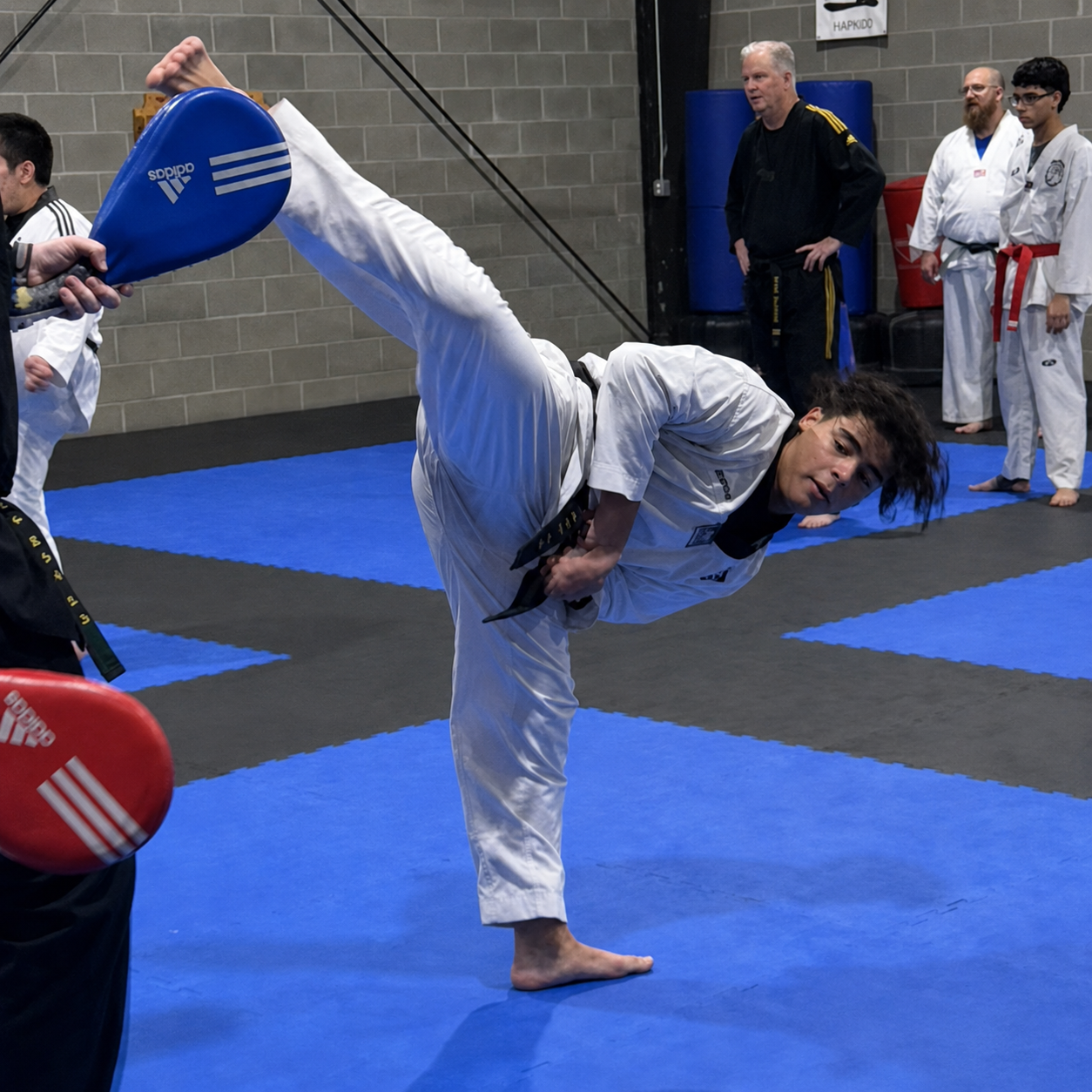 Adult Taekwondo student performing a hook kick during advanced martial arts training in Mt. Juliet.